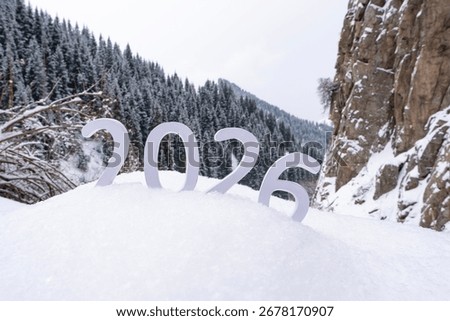Beginning of a new year. Changes 2026. Concept of new ideas, beginning of a new year, planning and setting goals to achieve new heights and successes in life. 2026 against the backdrop of mountains.