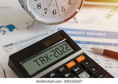 Beginning of taxes in 2022 with a calculator that calculates income In the business concept of paying taxes, withholding taxes in the new year 2022 and as a rule - Shutterstock ID 2051162627
