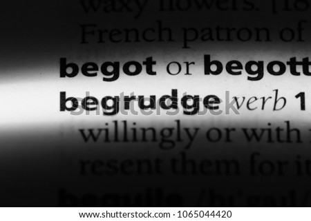 begrudge word in a dictionary. begrudge concept.