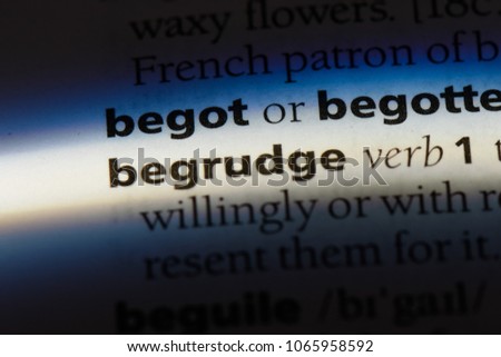 begrudge word in a dictionary. begrudge concept.
