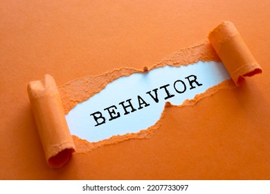 Behavior word written under brown torn paper.