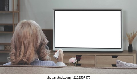 Behind Of Asian Young Woman Watching White Screen TV On The Sofa At Home
