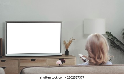 Behind Of Asian Young Woman Watching White Screen TV On The Sofa At Home
