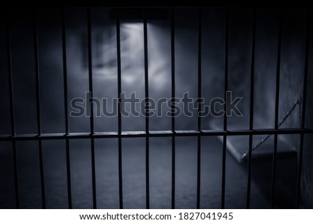 Behind bars concept. Obsolete grunge concrete room miniature. Dark prison interior creative decoration. Empty cell. Selective focus