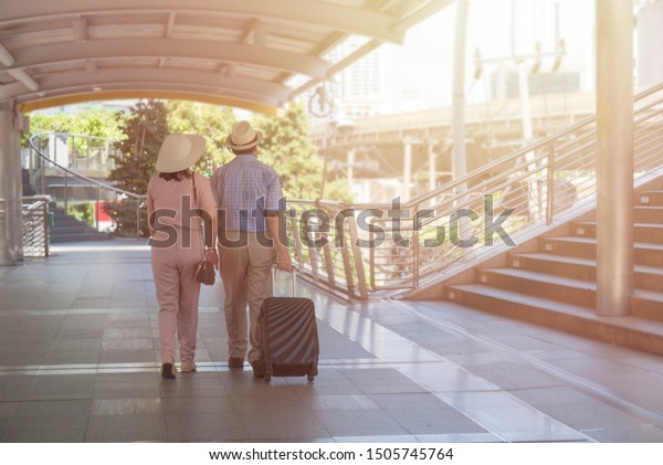 Behind Couple Senior Drag Luggage On Stock Photo Edit Now 1505745764