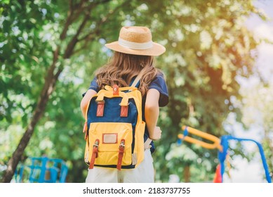 Behind The Female Tourist Carrying A Yellow Bag.