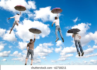 behind flying four friends with umbrellas on White, fluffy clouds in blue sky collage