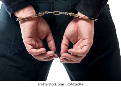 Behind the hand in handcuffs close-up, the criminal is caught! - Shutterstock ID 734616349