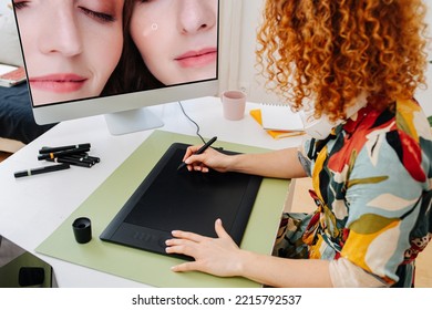 Behind Image Of A Woman Working On A Graphic Tablet, Looking At The Big Monitor With A Photo On It. She Is Sitting Behind The Desk. Wearing Motley Dress.