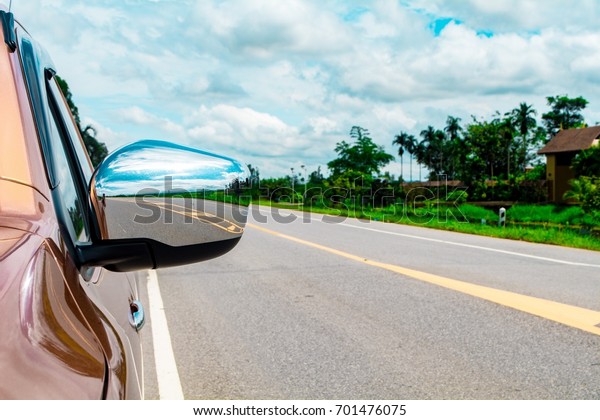 Behind of mirror wing\
and country road.