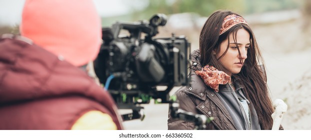 Behind The Scene. Actress In Front Of The Camera On The Film Set Outdoor Location. Group Movie Scene