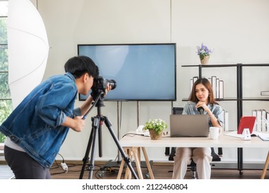 Behind the scene concept. Videographer prepare to record footage before streaming live online of young Asian woman blogger with studio lighting. broadcasting vlogger, internet influencer.