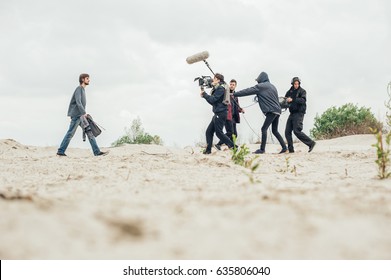 Behind the scene. Film crew team filming movie scene on outdoor location. Group cinema set - Shutterstock ID 635806040