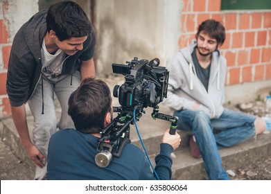 Behind The Scene. Film Crew Team Filming Movie Scene On Outdoor Location. Group Cinema Set