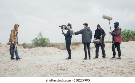 Behind the scene. Film crew team filming movie scene on outdoor location. Group cinema set - Shutterstock ID 638227990