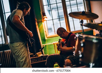 Behind The Scene. Rock Band Practice In The Messy Recording Music Studio. Alternative Musician Group Live Playing