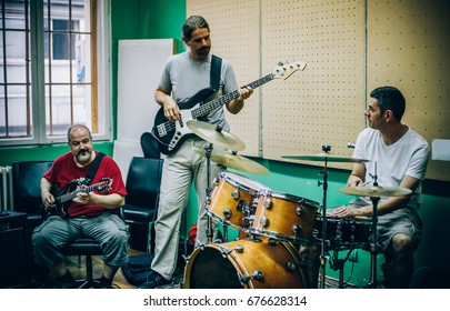 Behind The Scene. Rock Band Practice In The Messy Recording Music Studio. Alternative Musician Group Live Playing