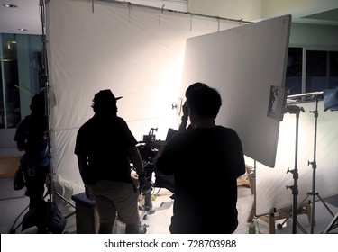 Behind The Scene Of Silhouette Film Crew Team Shooting Video Commercial Production And Camera Equipment In Home Studio.