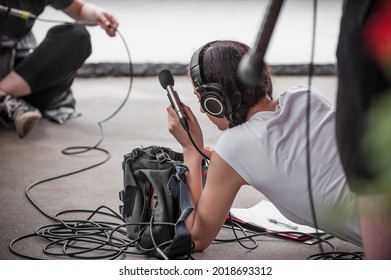 Behind The Scene. Sound Boom Operator Resting On The Set And Hold Microphone Fisher Outdoor