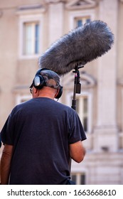 Behind The Scene. Sound Recorder With Microphone, Boom Mic And Headphones Filming Movie Scene On Outdoor Location 