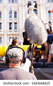 Behind The Scene. Sound Recorder With Microphone, Boom Mic And Headphones Filming Movie Scene On Outdoor Location 