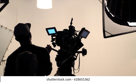 Behind The Scene Of Tv Movie Video Film Shooting Production Crew Team And Camera Lighting Set In The Big Studio.