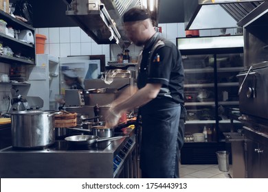 Behind the scenes of brands. The chef cooking in a professional kitchen of a restaurant meal for client or delivery. Open business from the inside. Meals during the quarantine. Hurrying up, motion. - Powered by Shutterstock