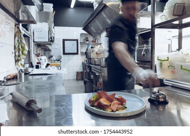 Behind the scenes of brands. The chef cooking in a professional kitchen of a restaurant meal for client or delivery. Open business from the inside. Meals during the quarantine. Hurrying up, motion. - Powered by Shutterstock