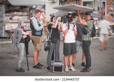 Behind The Scenes. Film Crew Team Shooting Movie Scene On Outdoor Location. Group Filmmaking Set Production