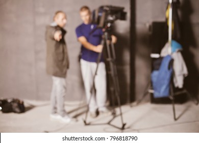 Behind the scenes or making of film in the studio and silhouette of cameraman, blurred image. blur image of group of stage staff for background usage. Vintage photo processing