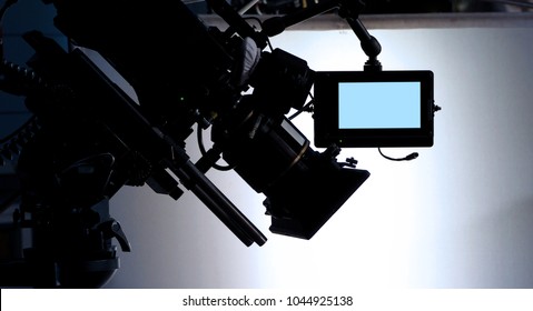 Behind The Scenes Or The Making Of Film Video Production And Movie Crew Team Working In Silhouette Of Camera And Equipment Set In Studio. 