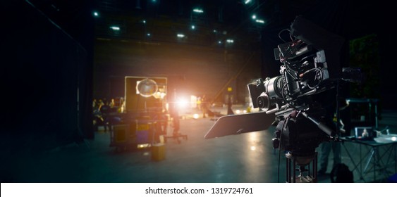 Behind the scenes of making of movie and TV commercial. Camera of movie and video production. Film Crew. B-roll, and crew team in studio and set on dark background