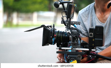 Behind The Scenes Of Movie Shooting Or Video Production And Film Crew Team With Camera Equipment At Outdoor Location.