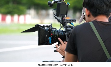 Behind The Scenes Of Movie Shooting Or Video Production And Film Crew Team With Camera Equipment At Outdoor Location.