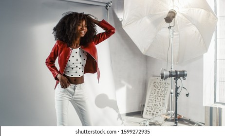 Behind The Scenes On Photo Shoot: Beautiful Black Model Poses For A Photographer. Stylish Fashion Magazine Photoshoot With Pro Equipment In A Studio