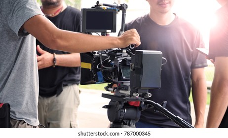 Behind The Scenes Of Outdoor Movie Video Production And Professional People Crew Team Working.