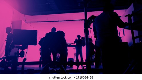 Behind the scenes of shooting video production and lighting set for filming movie which film crew team working in silhouette and professional equipment in studio for video. video production concept. - Shutterstock ID 1919034458