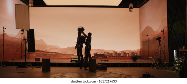 Behind The Scenes Shot Of Virtual Production Stage With Huge LED Screens, Cinematorgapher Shooting Mars Scene. Future Of Movie Production