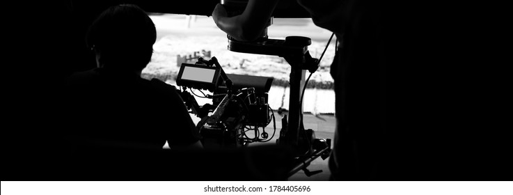 Behind the scenes of video production in studio which filming a online movie with professional set up such as high definition vdo camera, lens, monitor or tripod and crane beside crew team. - Shutterstock ID 1784405696