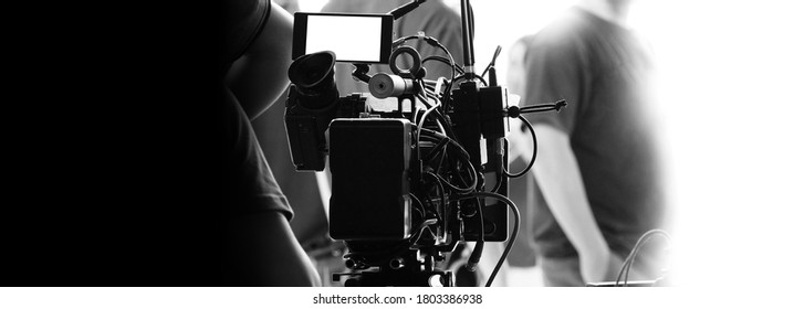 Behind the scenes of video recording or filming online movie by 8K high definition digital camera and professional monitor. And flare lighting set up with film crew team in the studio production.