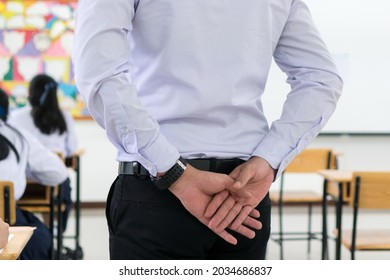 Behind Smart Asian teacher supervising exam in exams room looking all students highschool in testroom while thai uniform students concentration testing admission in secondary schools  Thailand. - Shutterstock ID 2034686837