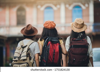 Behind View Of Woman Group Backpacker Travel On Street Together, Friendship Traveller Backpack Travel For New Experience. Asian Girl Team Traveling Thailand Trip.