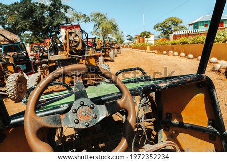 behind the wheel of  rusty buggy