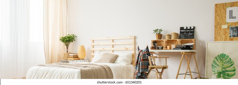 Beige bedroom with simple wooden desk and chair, panorama