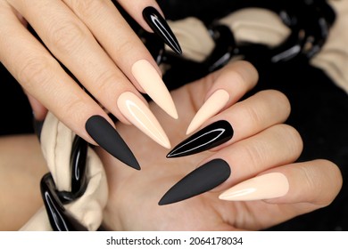 Beige and black manicure on long nails.