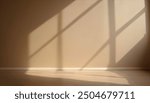 Beige blank wall interior background, with shadow from window. Background concept studio and backdrops show products.