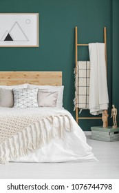 Beige Blankets On Bed And Ladder In Boho Bedroom Interior With Poster On Green Wall