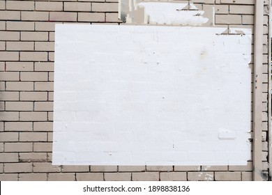 Beige brick wall with white empty street placard texture