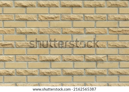 Beige bricks lined with a neat brick wall