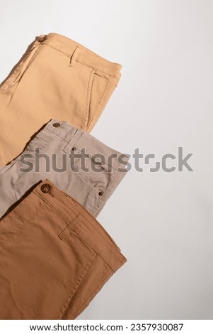 Beige casual pants. light brown pants. Beige pants background. men pants advertisement. pant ad. copy space. Casual jeans pant. Fashion, style. clothes advertisement concept. Beige female denim.